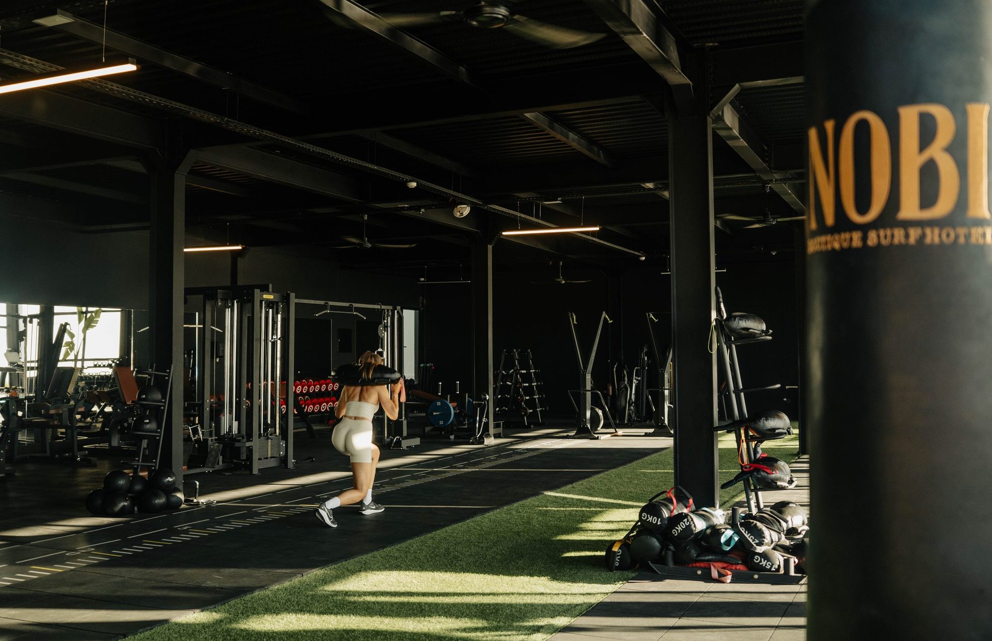 The 320 m2 gym floor at Nobi near Taghazout, turf lane and branded bag