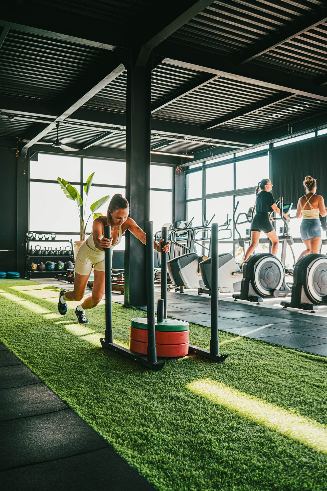 Pushing a loaded sled down the turf lane in the gym at Nobi, Taghazout Bay