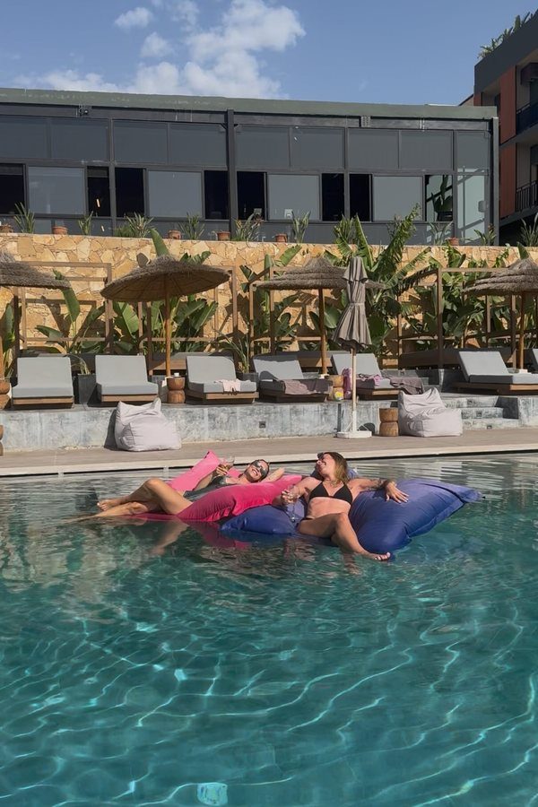 Floating on pool loungers in the afternoon