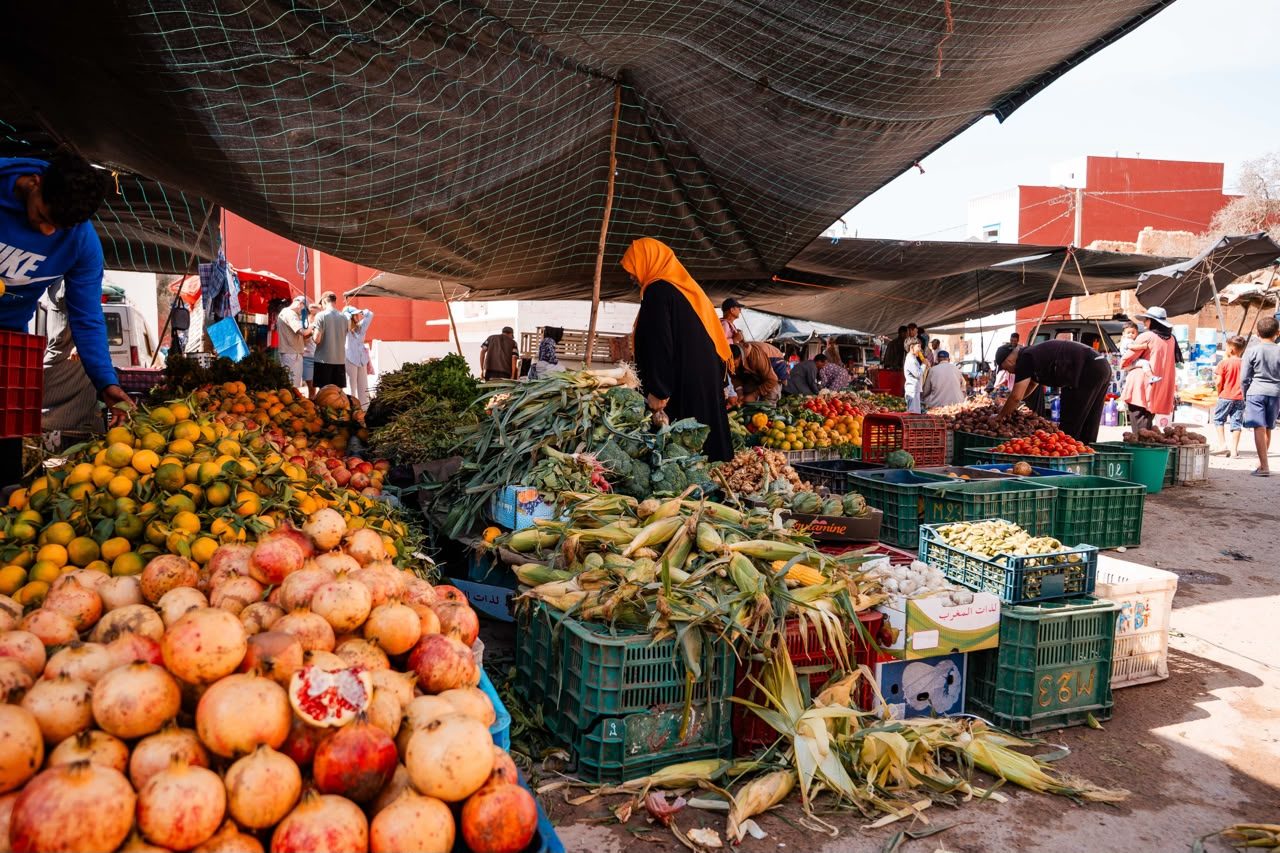 Pomegranates, corn and citrus on the stalls of the local market near Taghazout