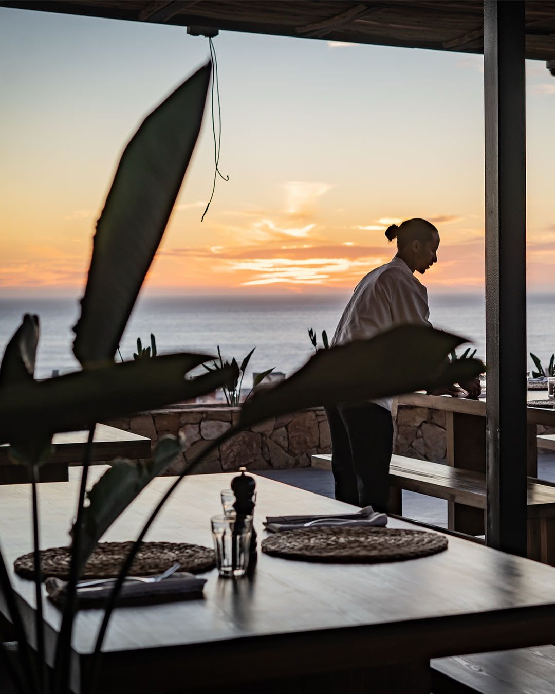 A table laid on the terrace as the sun sets over Taghazout Bay