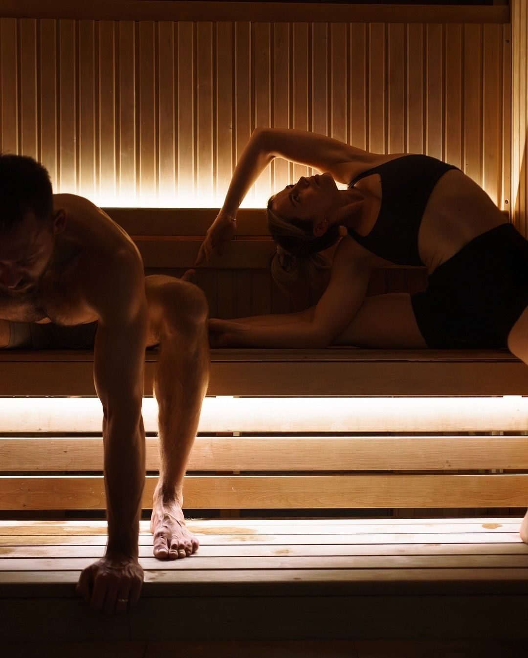 Two guests stretching on the benches of the bio sauna