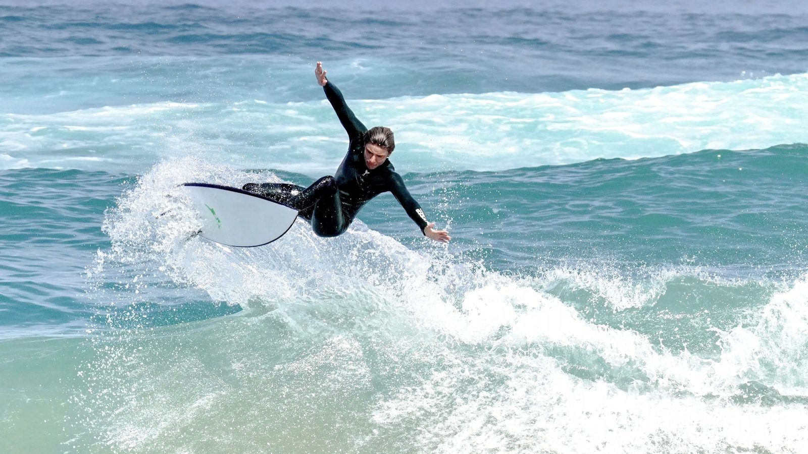 An experienced surfer turning on a wave near Tamraght in Taghazout Bay